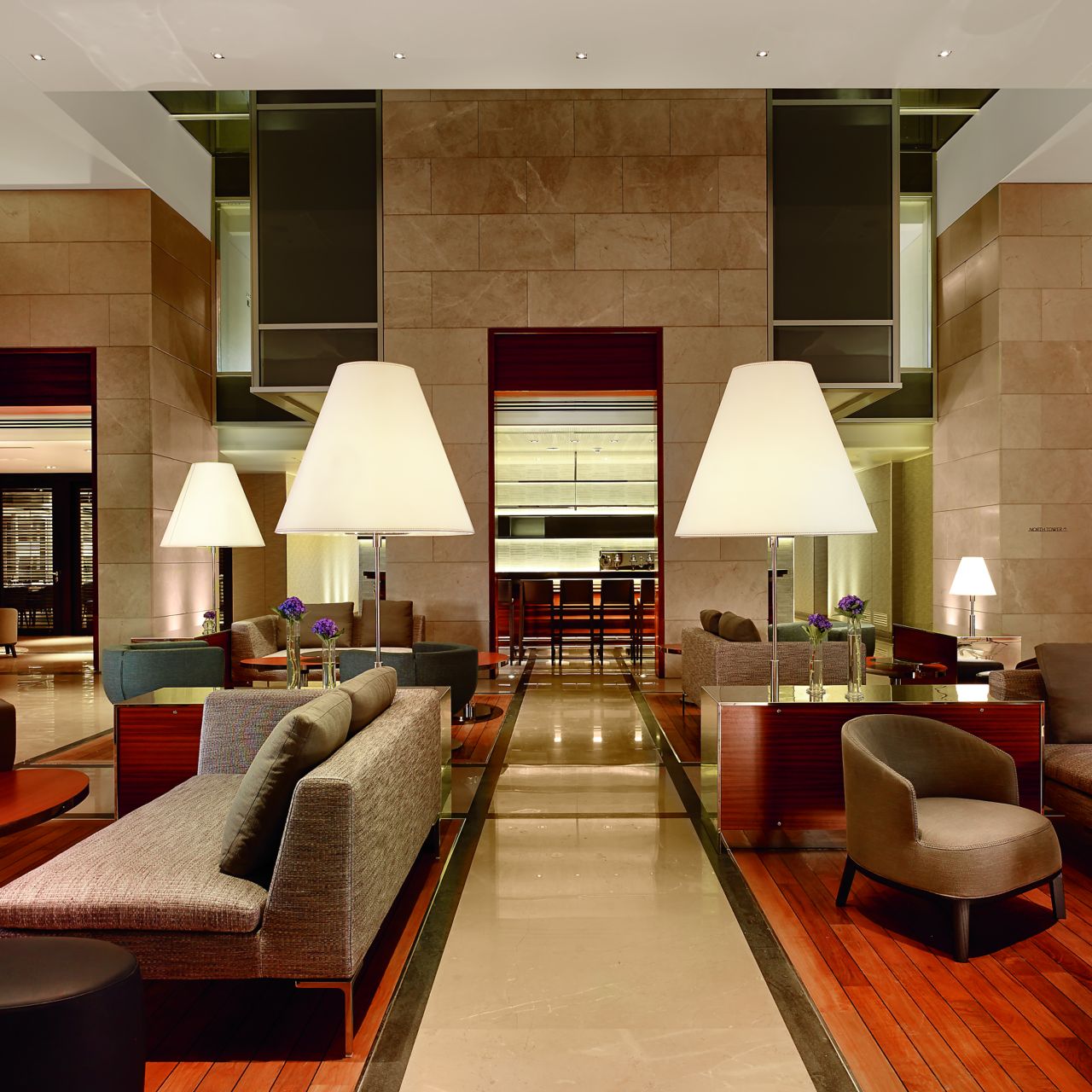 The Lobby Lounge at evening with rich woods, cool stone and intimate seating