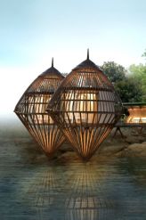Five cocoon-shaped pavilions wrap around the rocky shore of the spa building, which is sandwiched by the rainforest and sea