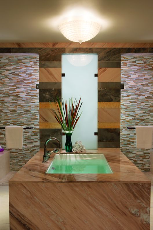 A contemporary soaking bathtub in the Ritz-Carlton Suite master bedroom