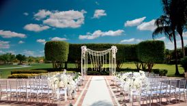 Bright white dominates the wedding décor, from the whimsical outdoor altar to the grand floral arrangements