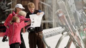 A family looks at a ski map