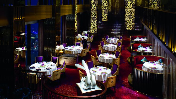 Aerial view of Jin Xuan?s dining room with crimson carpet, amethyst upholstered seating and gold patterns on the walls