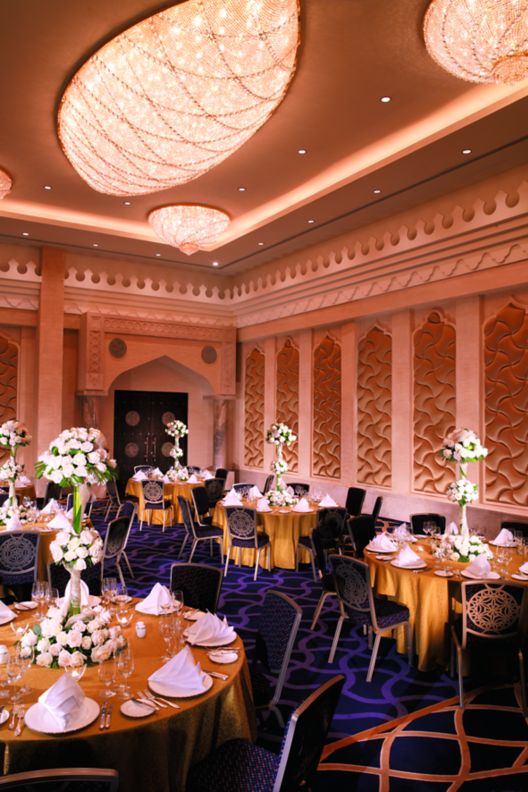 Reception room set up with round tables with centerpieces.