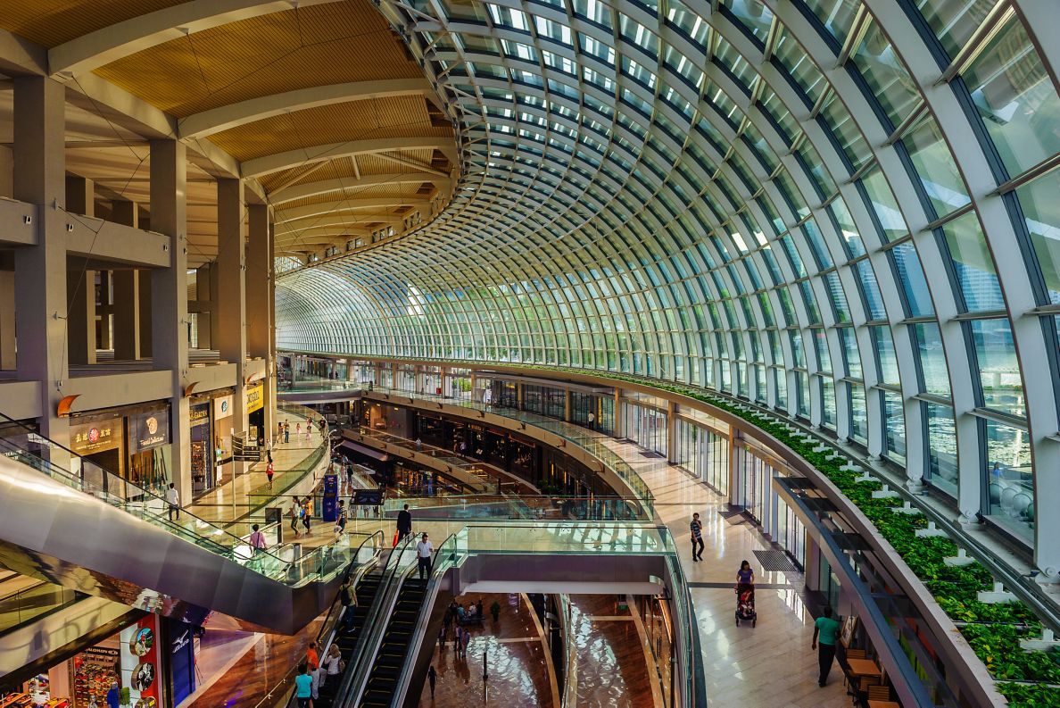 Aerial view of the inside of a mall with a domed glass wall.