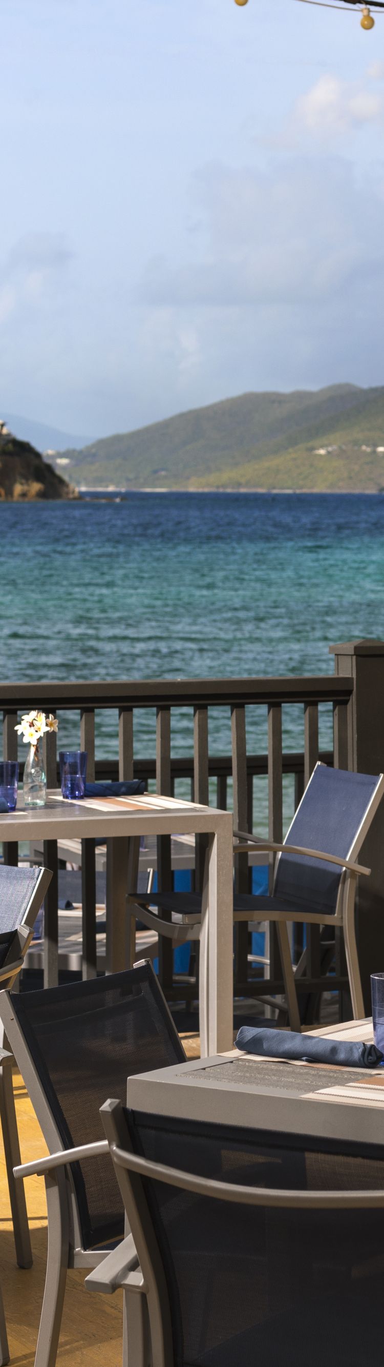 Outdoor patio with dining tables and ocean views