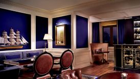 Room with a mural-embellished bar, nautical artwork and multiple seating areas
