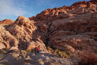 Two people looking at a rock formation