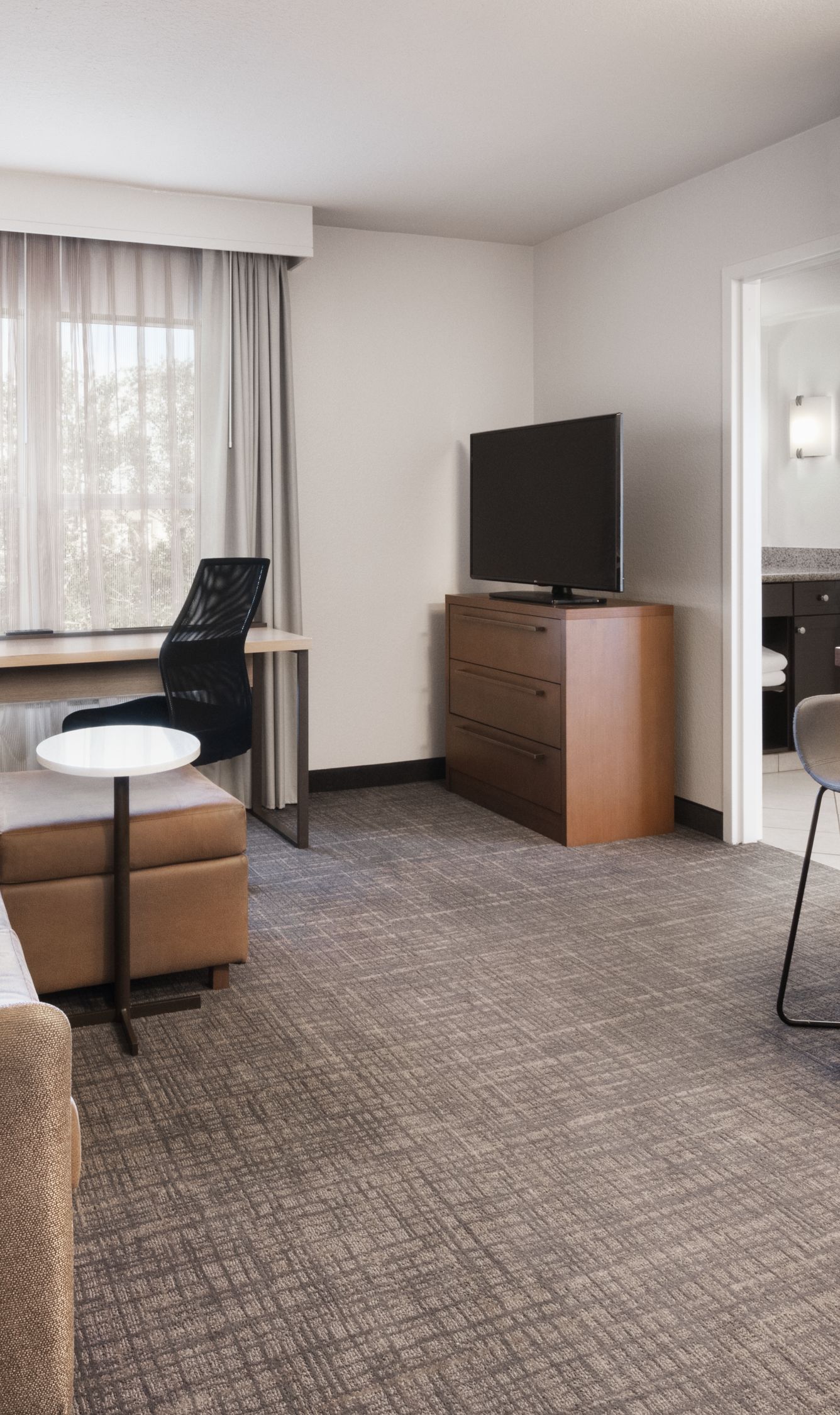 Suite living room with sofa and table and desk