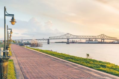 Riverfront path with bridge in background
