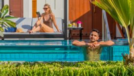 Couple enjoying time at the pool at a private villa