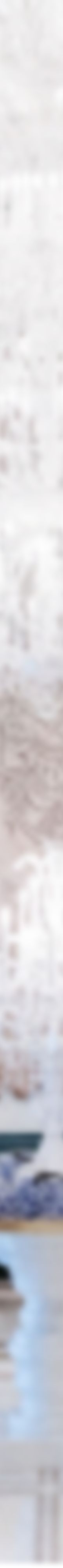 Woman stands in all-white hotel lobby