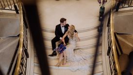 Wedded couple sitting on grand staircase
