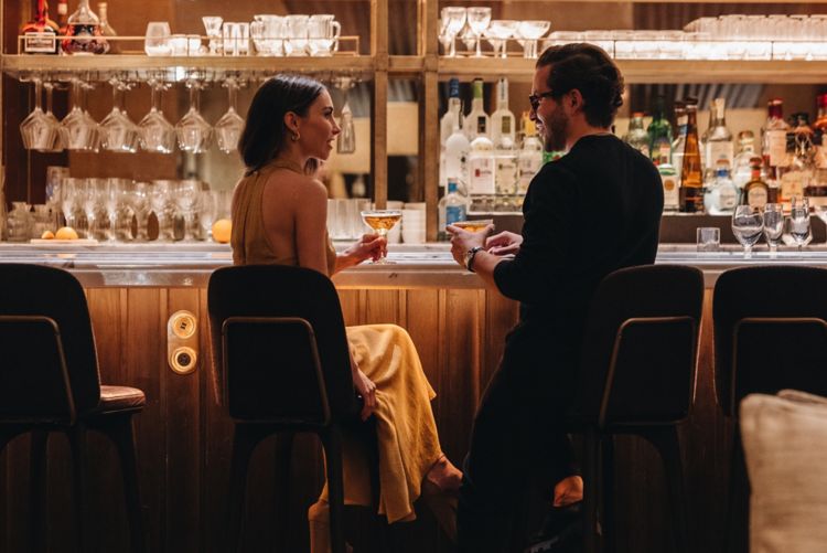 Man and woman sitting at bar.
