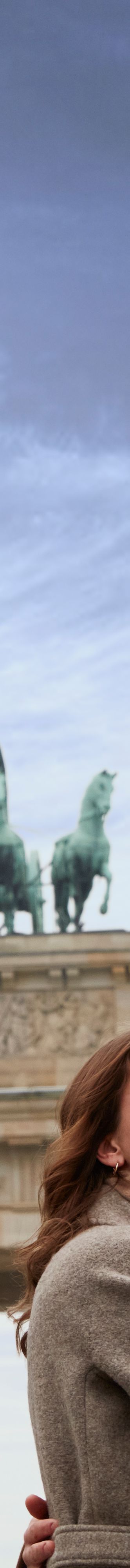 Couple is at the Brandenburg Gate in Berlin during