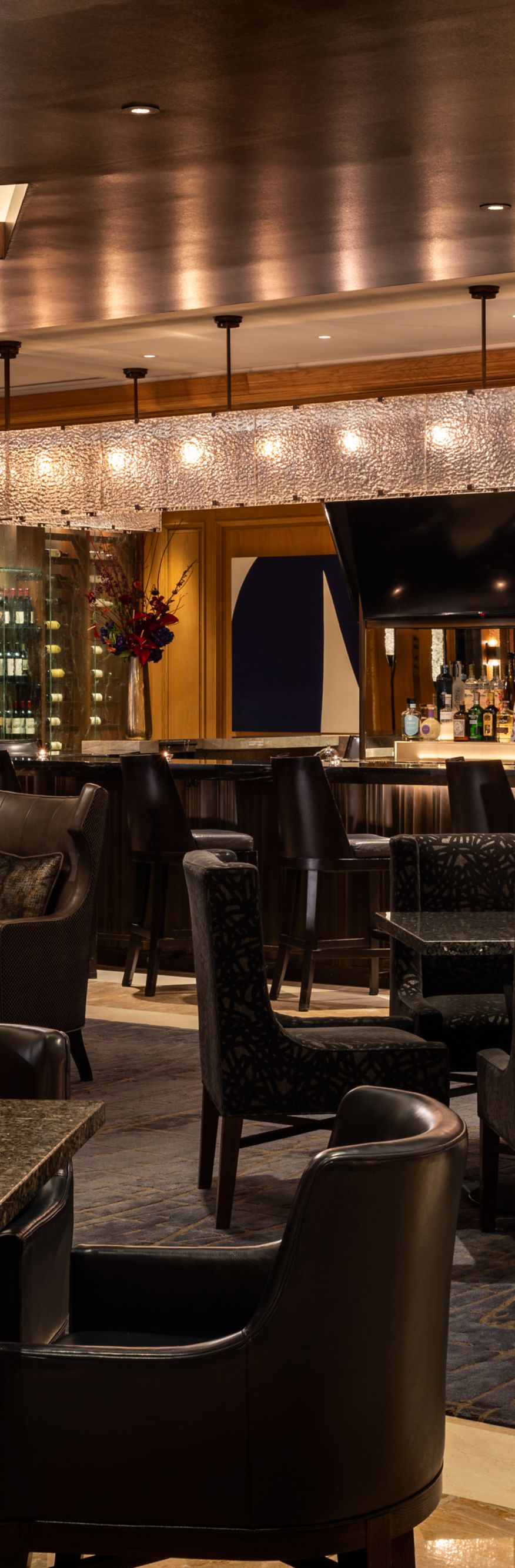 Restaurant with numerous black tables and chairs