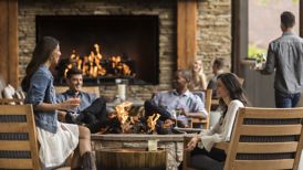 couples sitting on patio, fireplace, happy hour