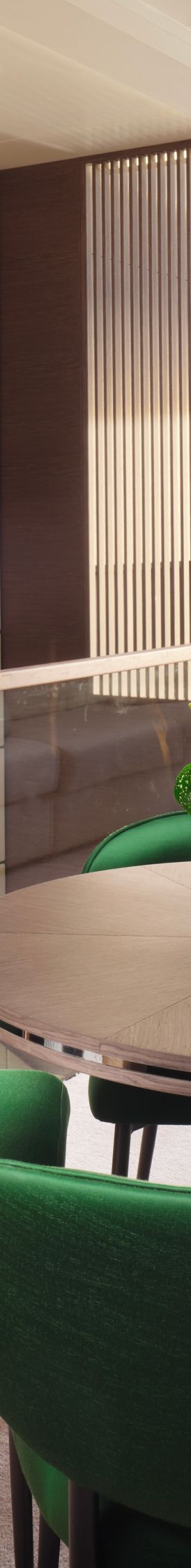 A dining area in a yacht's cabin with green chairs