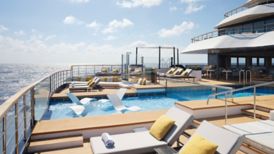 Lounge chairs around a pool on a yacht deck
