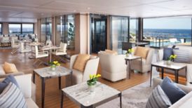 A lounge aboard a yacht that opens to the outdoors