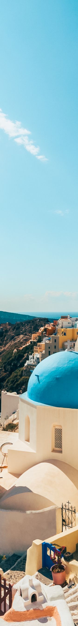 Whitewashed buildings line the seaside in Greece