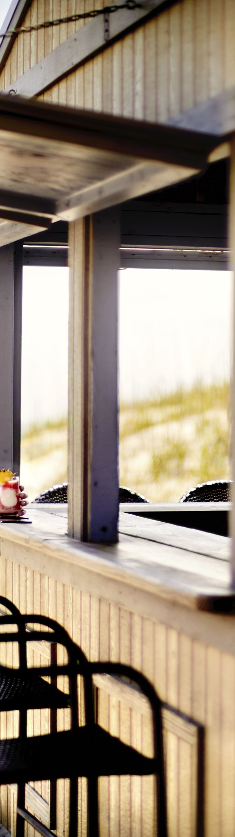 two women enjoying cocktails at bar on the beach