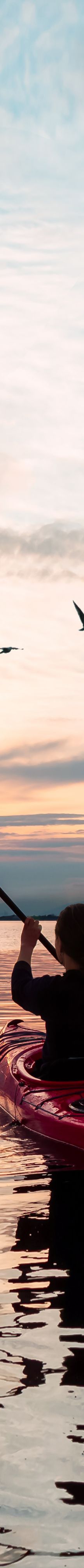A sea kayaker at sunset