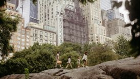 Picture of family of four walking with skyscrapers