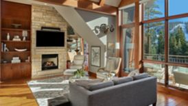 Living room with couch, decor, slopeside view, and