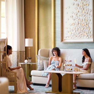 Three women sitting in lobby area 
