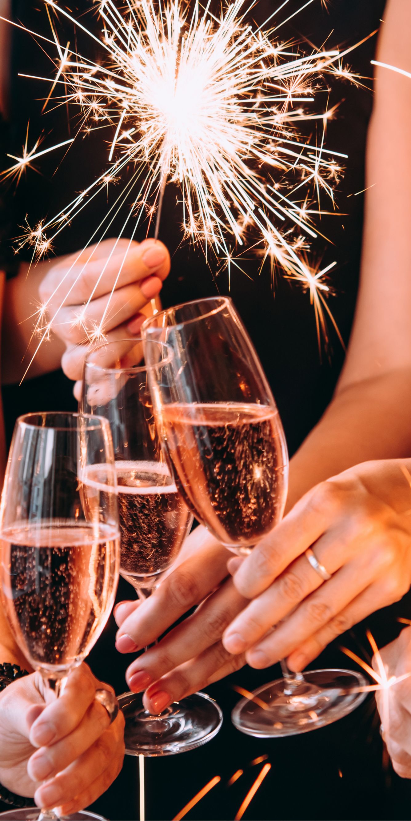 Friends with champagne glasses and sparklers