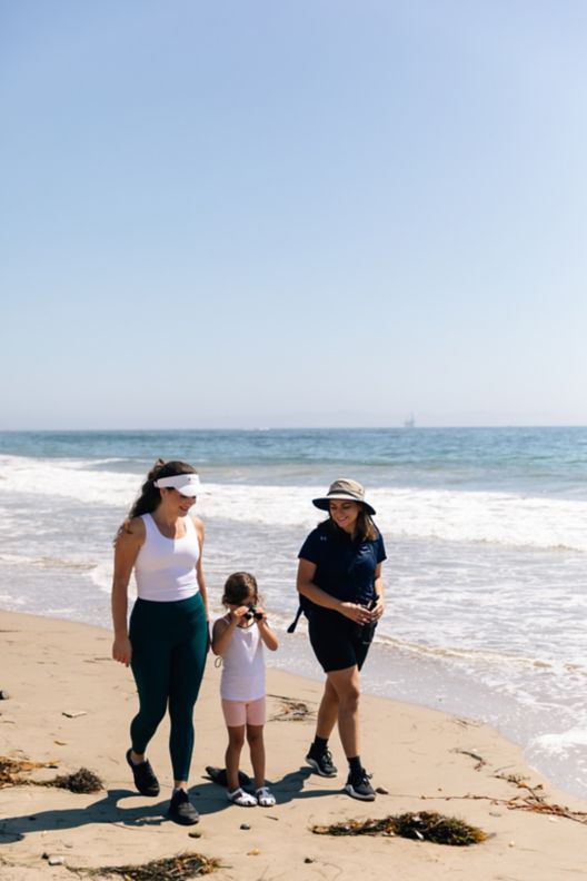 Family stroll along the beach with nature guide