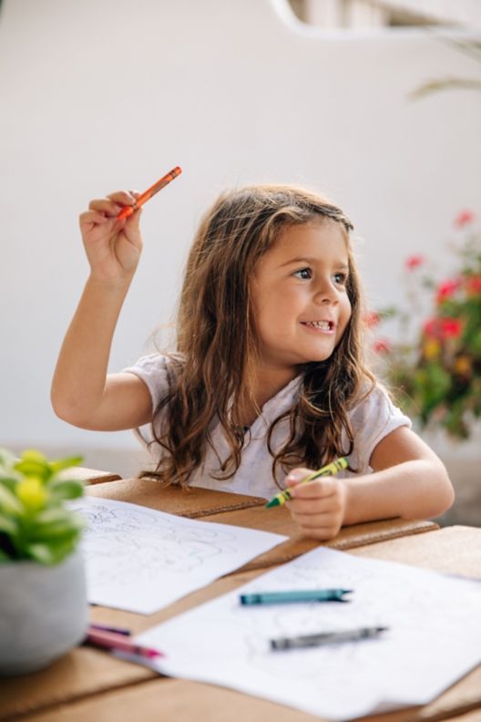 Toddler playing with crayons and Ritz Kids  