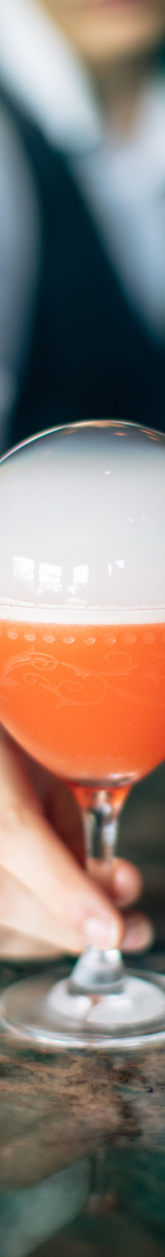 Signature orange color cocktail with smoke bubble.