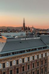 A Vienna hotel roof against the skyline at sunset