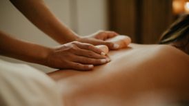 Hot Stone treatment on person's back at Spa