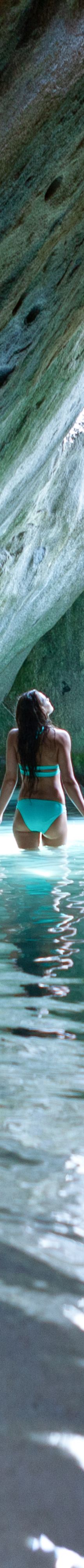 A woman walks through rock formations in Virgin Go