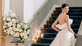 Bride on stairs looking over shoulder at camera