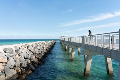 Person on pier looking at water
