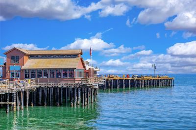 A pier surrounded by water in direct sunlight