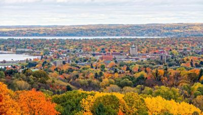 A small city surrounded by trees in autumn colors