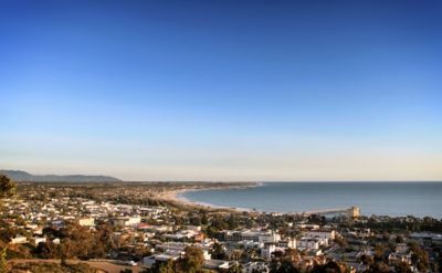 A bird's-eye view of a city with ocean in the background