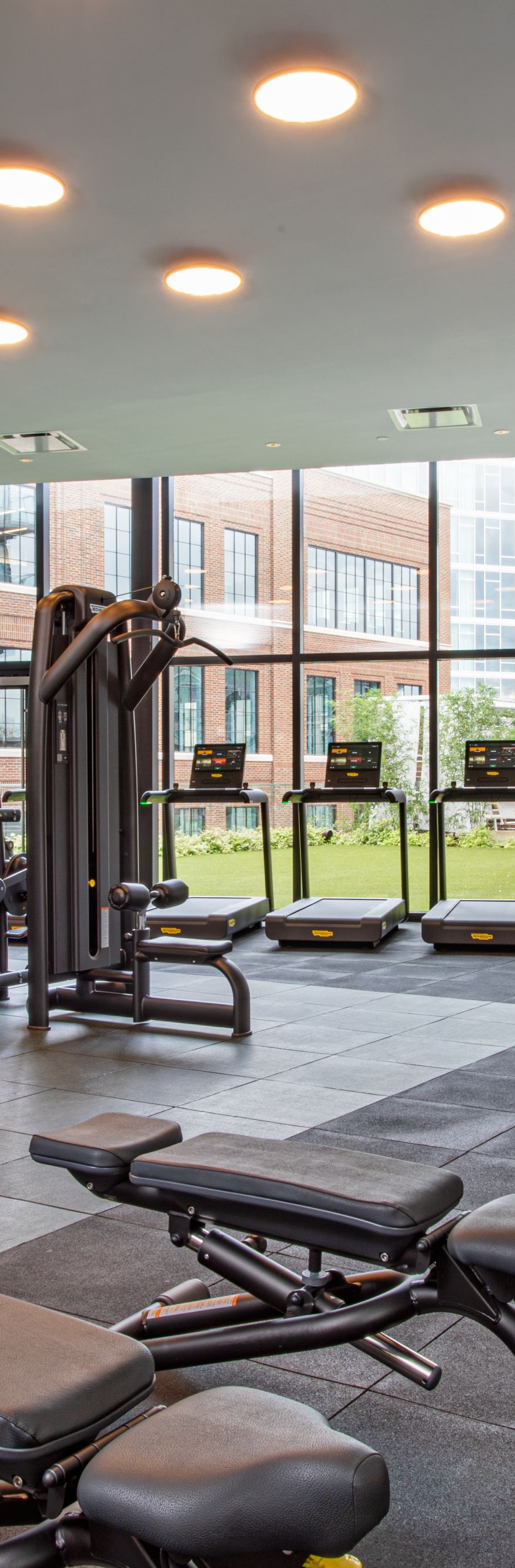 Fitness center with wall to ceiling windows. 