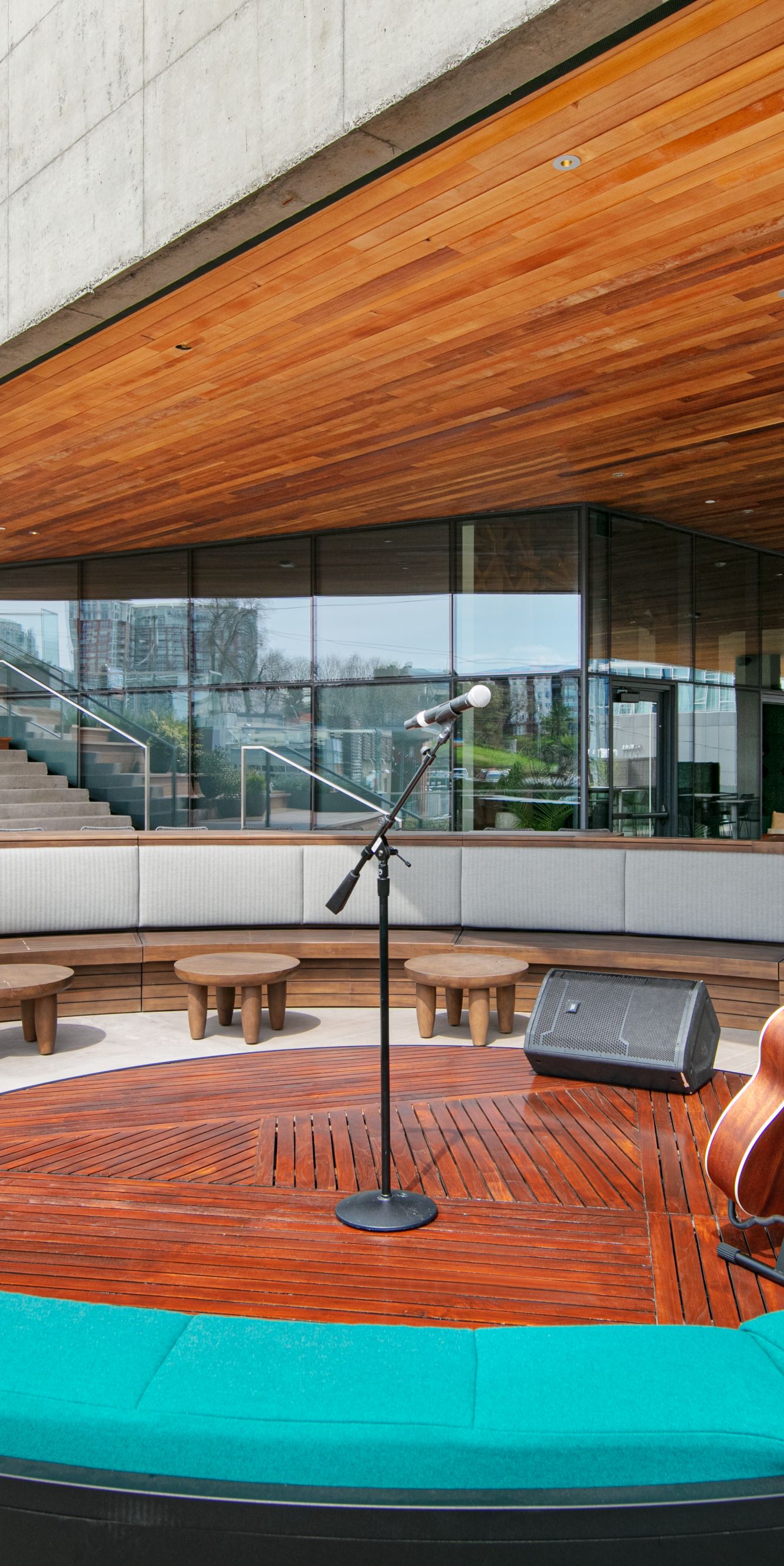 Guitar and microphone on an outdoor stage.