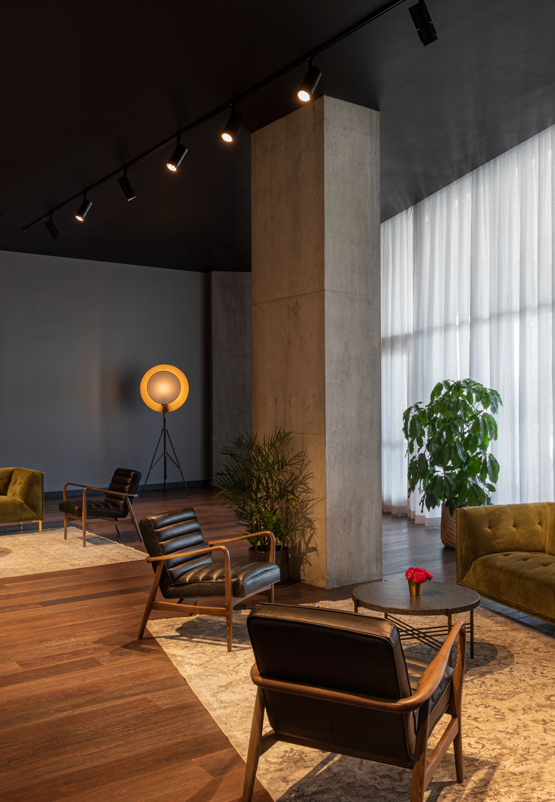 Soft seating inside room with bar and windows.