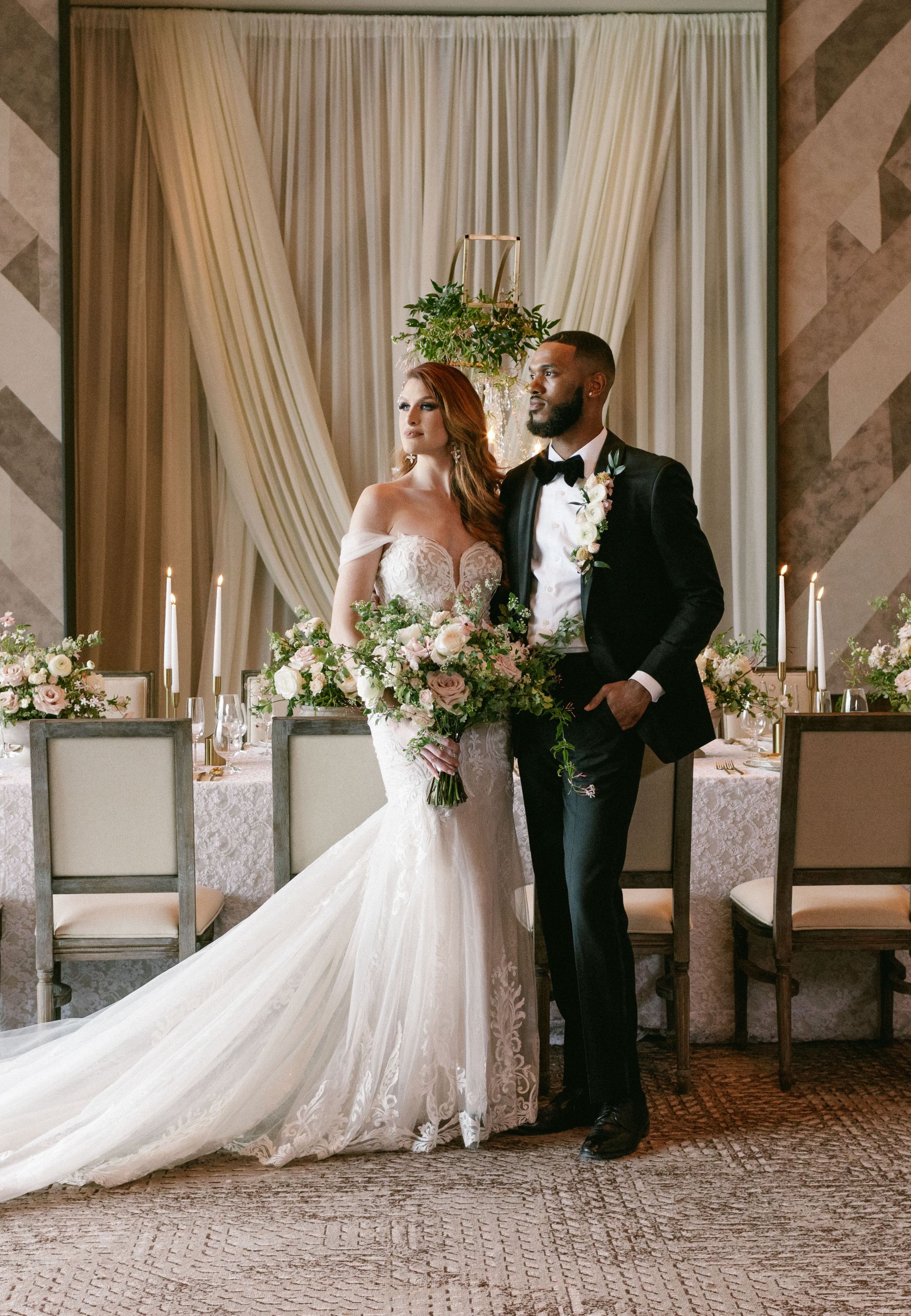 Bride and groom standing in front of table. 