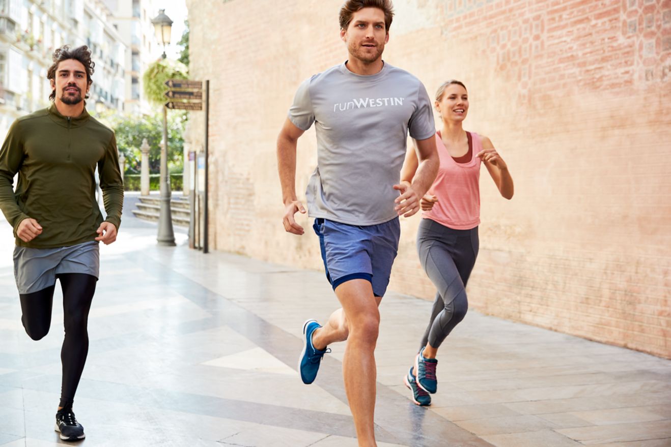 Three people running together.