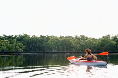 A woman kayaks on a lake