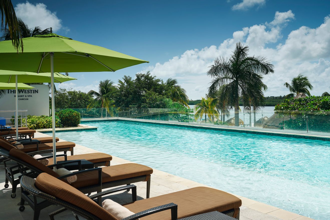 Pool with lounge chairs and umbrellas