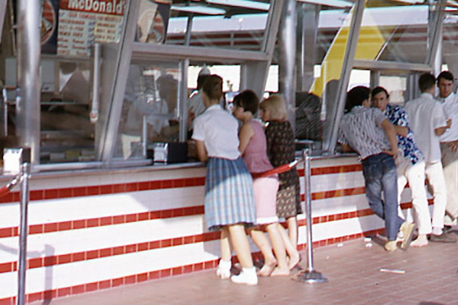 Several people ordering food at the first McDonald's storefront
