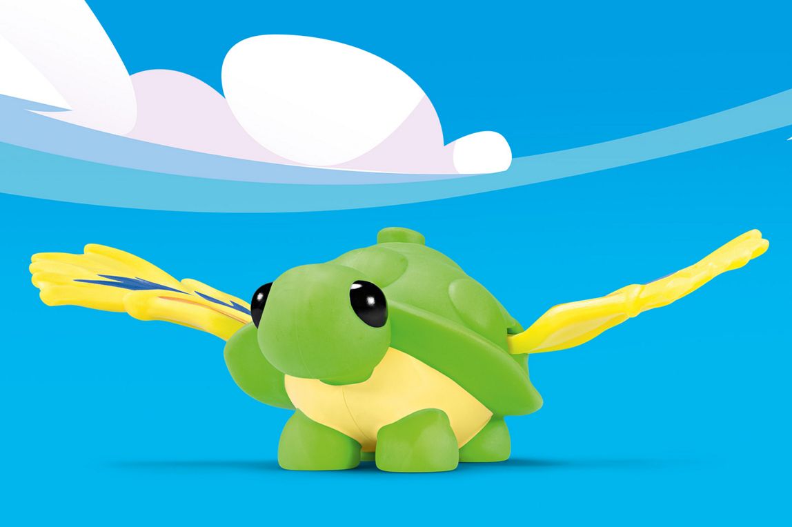 Eine grüne fliegende Schildkröte-Figur mit gelben Gliedmaßen und gelb-grünen, stilisierten Federflügeln.